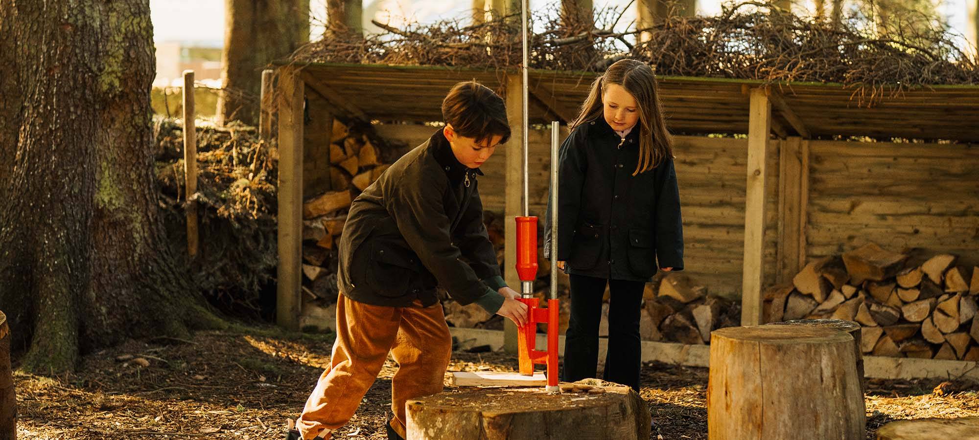 Two children taking part in outdoor woodland activities at Gleneagles