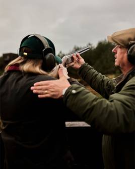 Woman being coached at High Moor Shooting Lodge, Gleneagles
